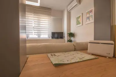 a living room with a couch and a window at Suite Color Family Roma in Rome