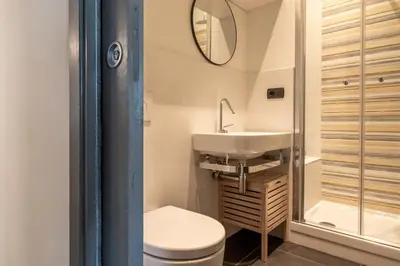 a bathroom with a toilet and a sink and a mirror at Suite Color Family Roma in Rome