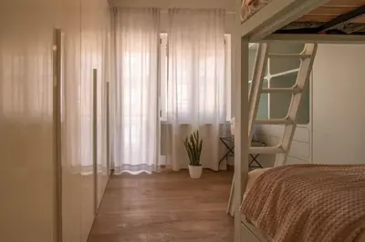 a bedroom with a bunk bed and a window at Suite Color Family Roma in Rome