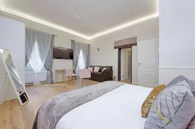 a bedroom with a bed and a living room at Cozy new flat near the Station! in Rome
