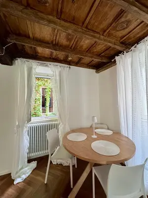 a table and chairs in a room with a window at Navona Fox House 1 in Rome