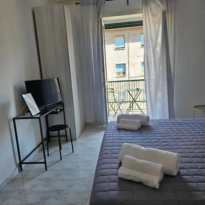 a bedroom with a bed with a television and a window at Casa Nostra a Centocelle in Rome