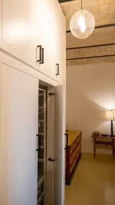 a hallway with a white door and a table at Domus Oro nel cuore di Roma in Rome