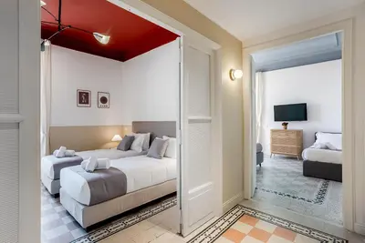 a bedroom with two beds and a sliding glass door at Flowers Apartment - grande casa a Montesacro in Rome