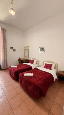 a large bedroom with a large bed and a couch at Niam House Volturno in Rome