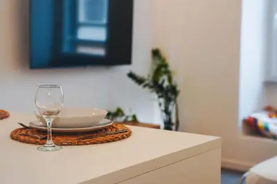 a table with a plate and a wine glass on it at Carlo Alberto Suite in Rome