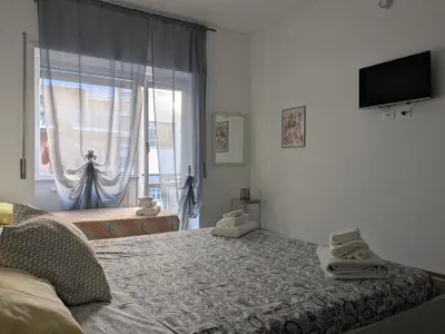 a bedroom with a bed and a window at Isolina 63 in Rome