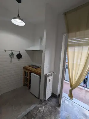 a kitchen with a counter and a sink and a window at Isolina 63 in Rome