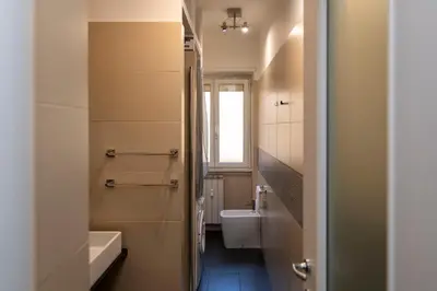 a small bed in a room with a blue wall at Apartment Marconi 2833 in Rome