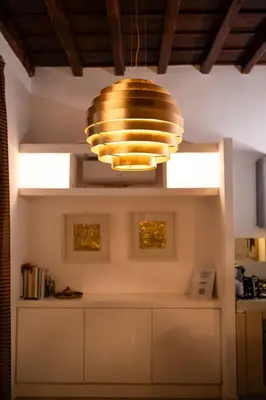 a kitchen with a large gold light hanging from the ceiling at Gold Spanish's Steps in Rome