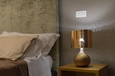 a lamp sitting on a table next to a bed at Gold Spanish's Steps in Rome
