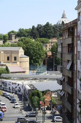 a view of a city with a train on a street at Rome Inn Vatican View Rooms in Rome