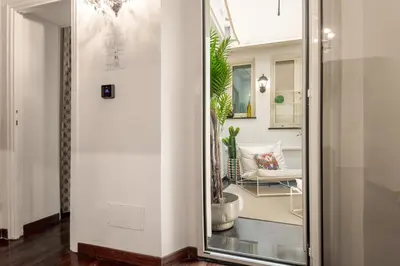 a hallway with a glass door leading into a living room at Donna Maria Apartment in Rome