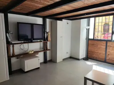 a living room with a flat screen tv on a wall at Termini CARMELOFT in Rome