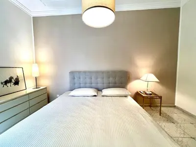 a bedroom with a large white bed and a lamp at My Roman Home - Prati Vaticano in Rome