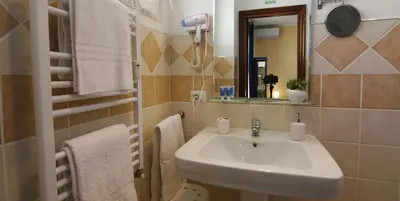 a bathroom with a sink and a mirror at B&B La Perla di Roma in Rome