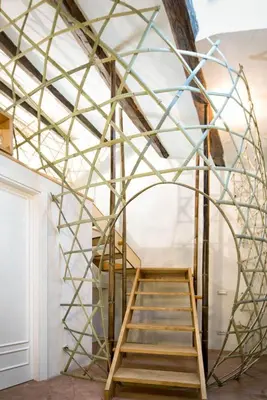 a metal frame stairway in a room with a ladder at Ghetto Luxury Design Apartment in Rome