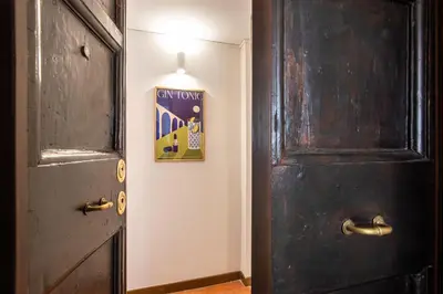 a door with a picture on the wall next to it at Barchetta Loft in Rome