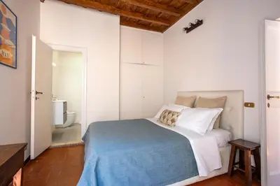 a bedroom with a bed and a bathroom at Barchetta Loft in Rome