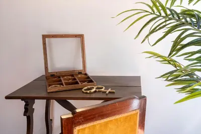 a table with a mirror and a pair of scissors on it at Barchetta Loft in Rome