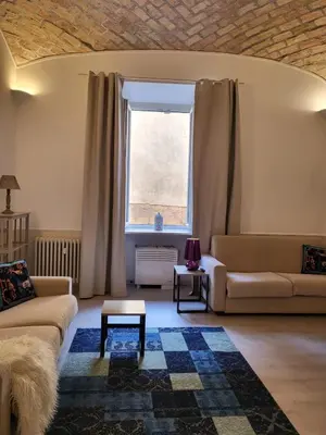 a living room with a couch and a table at Monteoppio one in Rome