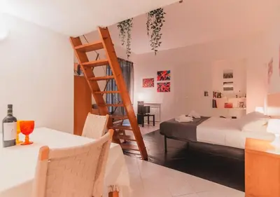a bedroom with a bed and a ladder in a room at Delizioso loft vicino Piazza del Popolo in Rome