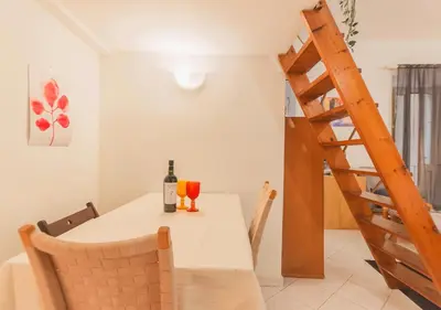 a dining room with a table and a bottle of wine at Delizioso loft vicino Piazza del Popolo in Rome