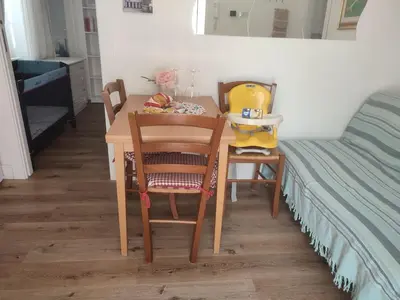 a small table with two chairs and a bed at casetta romana in Rome