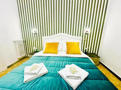 a bedroom with a bed with towels on it at Rome Termini Down-town Accommodation in Rome