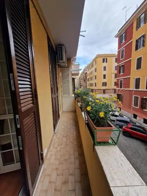 a balcony with potted plants and flowers on a building at Casa Claudia in Rome