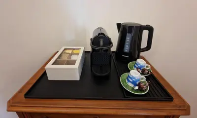 a table with a coffee maker and a box on it at Casa Claudia in Rome