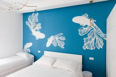 a bedroom with a blue wall with drawings of jellyfish at Roma Tiburtina - Elementcity Suites in Rome