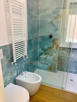 a bathroom with a sink and a toilet and a shower at Roma Tiburtina - Elementcity Suites in Rome