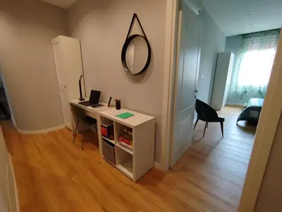 a room with a desk and a mirror on the wall at Hub in R'home in Rome