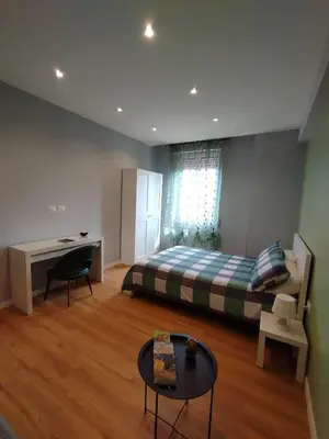 a bedroom with a bed and a desk and a table at Hub in R'home in Rome