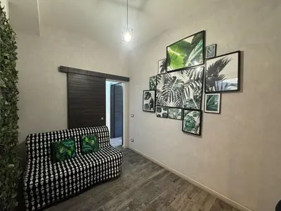 a living room with a couch and pictures on the wall at Relax & Explore Stylish Apartment in Rome in Rome