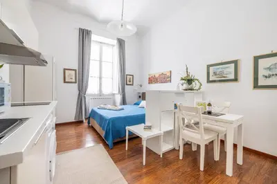 a small room with a bed and a table and chairs at Monti apartment in Rome