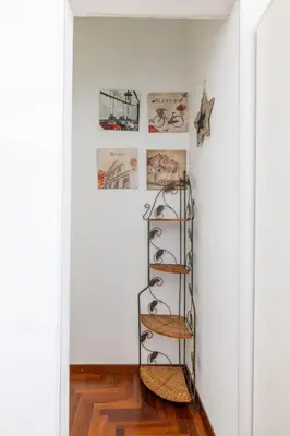 a shelf in a room with photos on the wall at Monti apartment in Rome