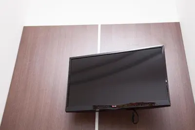 a flat screen tv hanging on a wall at Maison Maneli in Rome