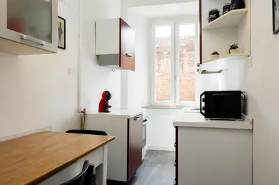 a bathroom with a toilet and a sink at Fernando’s Apartment in Rome