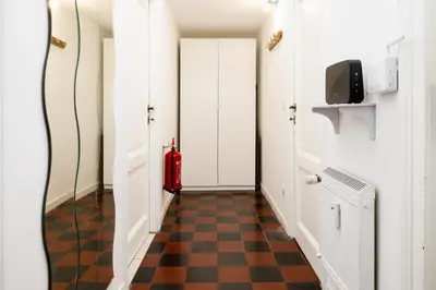 a white bedroom with a bed with towels on it at Fernando’s Apartment in Rome
