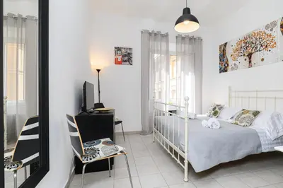 a bedroom with a bed and a desk and a mirror at Sanniti Luigi Cozy Home in Rome
