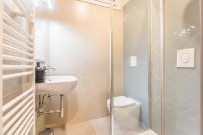 a bathroom with a toilet and a sink and a shower at EP2000 Roman Holidays in Rome