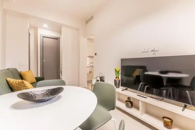 a living room with a white table and chairs and a television at EP2000 Roman Holidays in Rome