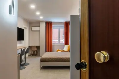 a bedroom with a bed and a desk in a room at GuestHost - Studio Apartment MM Cipro Rome in Rome