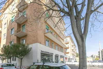 a building with a car parked in front of it at BB Trastevere Station - Room2 in Rome