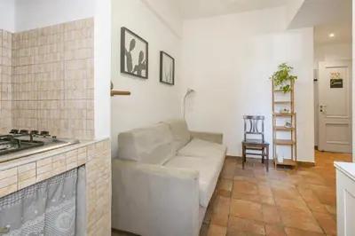 a living room with a couch and a kitchen at BB Trastevere Station - Room3 in Rome