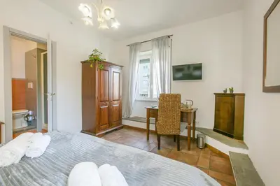 a bedroom with a bed and a desk and a table at BB Trastevere Station - Room3 in Rome
