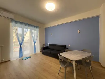 a living room with a table and a couch at Casa Emma in Rome