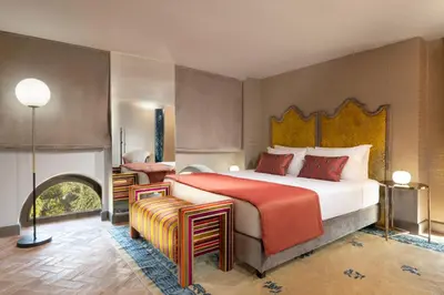 a bedroom with a large bed and a fireplace at Torre della Luna Roma Lusso, Privacy e Piscina con Vista su San Pietro in Rome